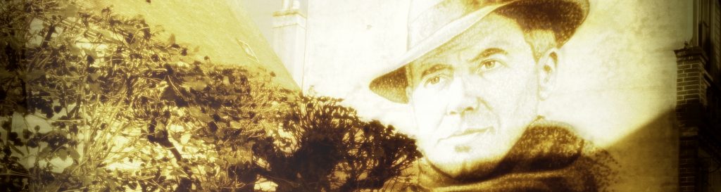 Photographie d'un portrait de Jean Moulin dessiné sur la façade d'une maison.