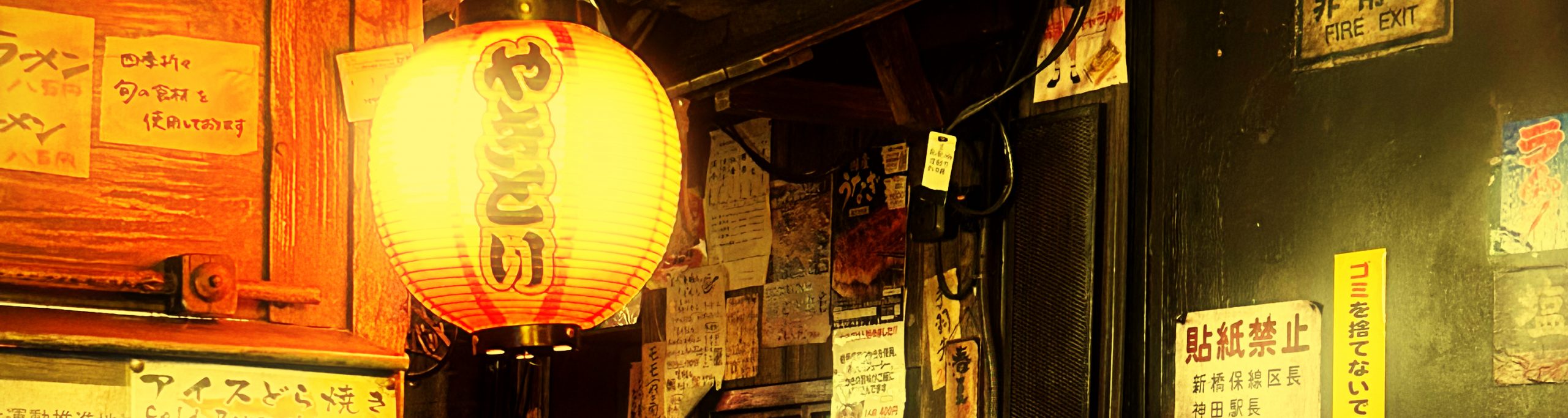 Photographie d'une restaurant traditionnel japonais. Les lampes en papier, les murs bruts, les affiches collées