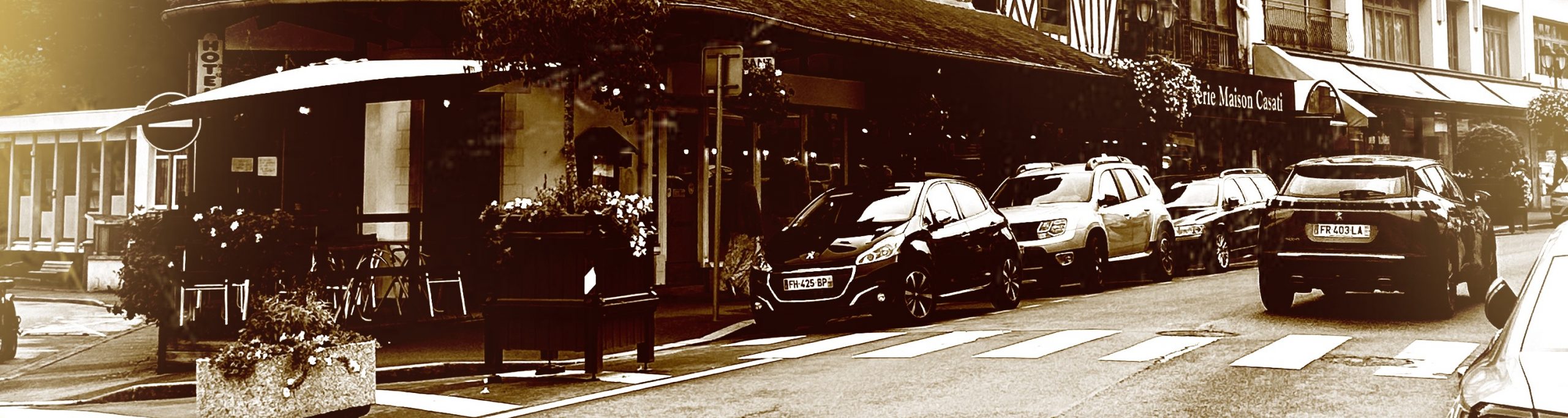 Photographie du rue de bagnoles de l'orne. Au premier plan, la tourelle aux motifs à damier d'un hôtel.