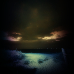 Photographie représentant la plage de Cabourg une nuit d'été. La lune éclaire le sable.